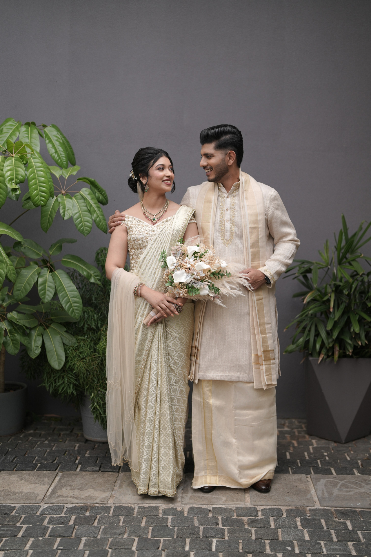 Bride and groom in ivory Kerala attire before the Catholic ceremony