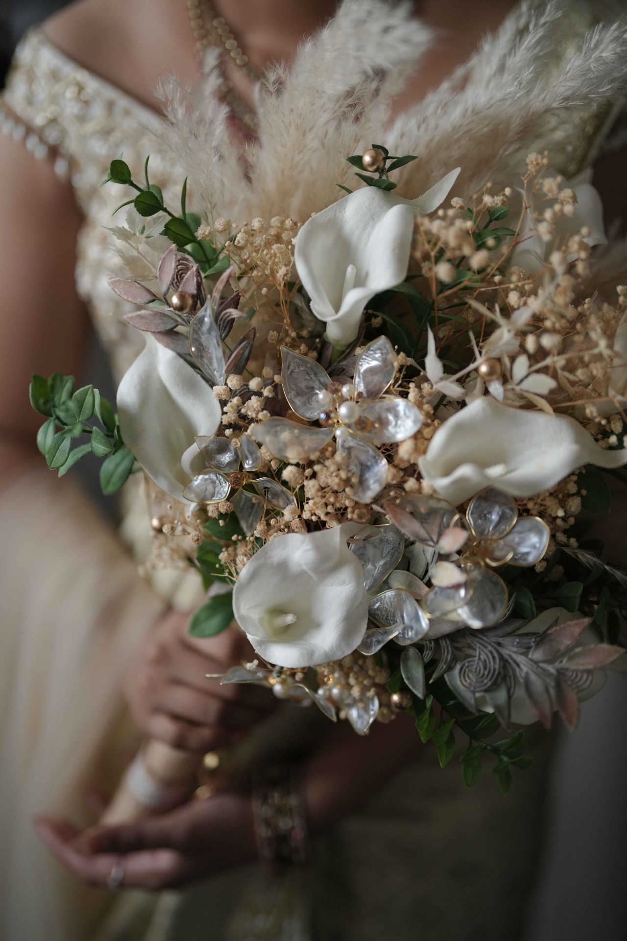 Bridal bouquet of white calla lilies and pampas grass